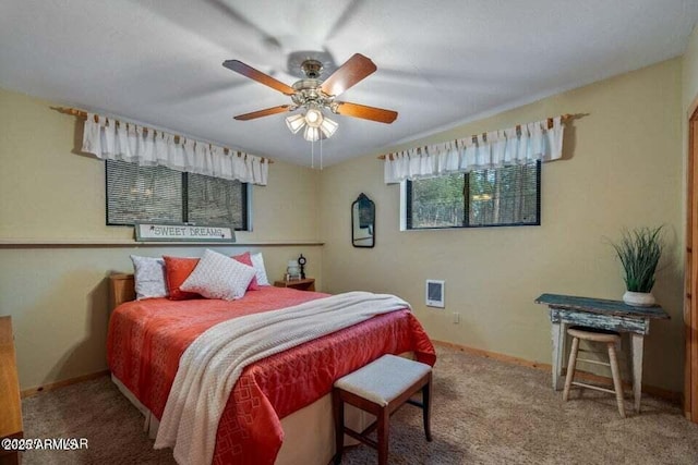 carpeted bedroom featuring a ceiling fan and baseboards