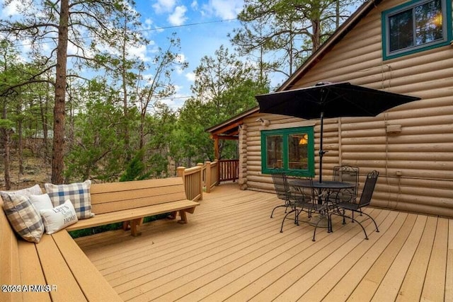 wooden deck featuring outdoor dining area