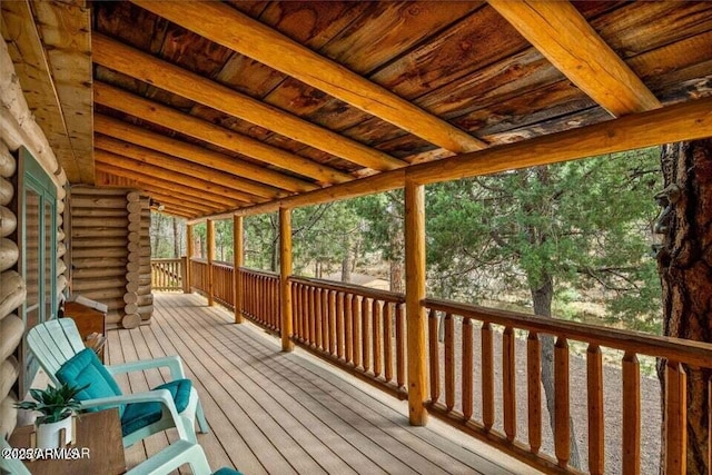 unfurnished sunroom featuring beamed ceiling