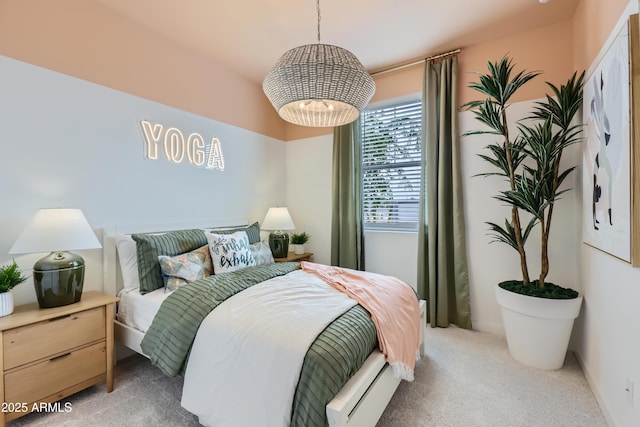 bedroom featuring light carpet and a notable chandelier