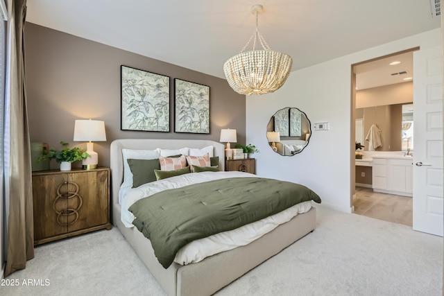 bedroom featuring light carpet, ensuite bath, visible vents, and a notable chandelier