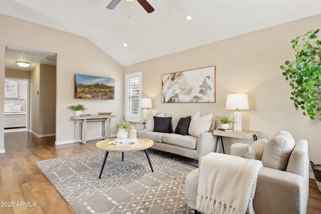 living room featuring ceiling fan, wood finished floors, lofted ceiling, and baseboards
