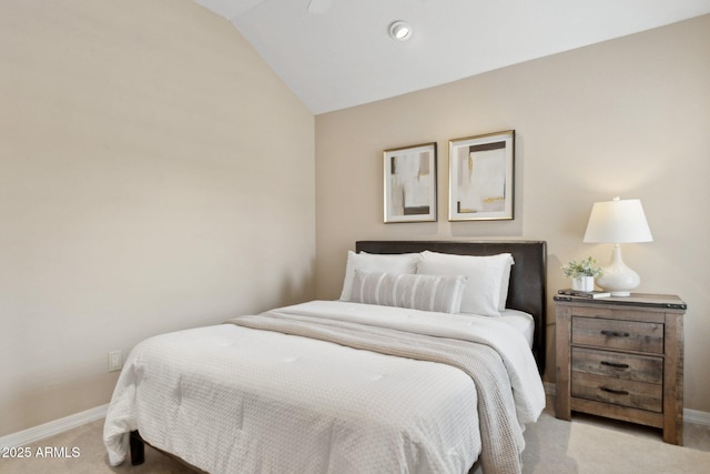 bedroom with carpet flooring, lofted ceiling, and baseboards