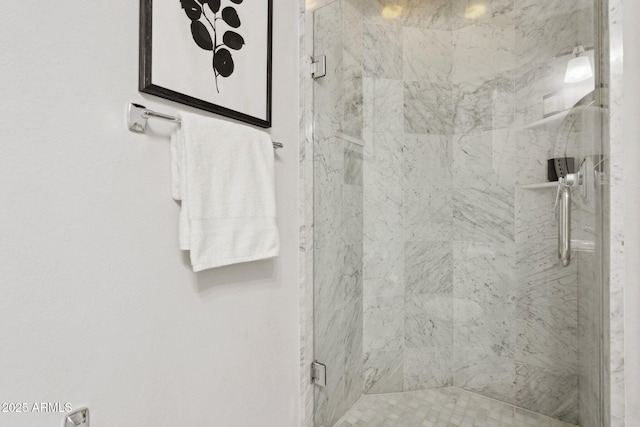 bathroom featuring a marble finish shower