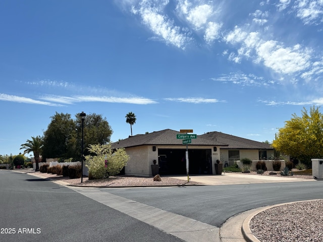 9621 E Calgary Ave, Sun Lakes, AZ 85248 - ranch-style home featuring an attached garage, stucco siding, and driveway
