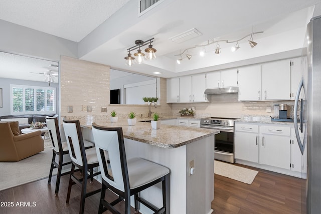 9621 E Calgary Ave, Sun Lakes, AZ 85248 - kitchen with stainless steel appliances, white cabinetry, dark wood-style flooring, and a textured ceiling
