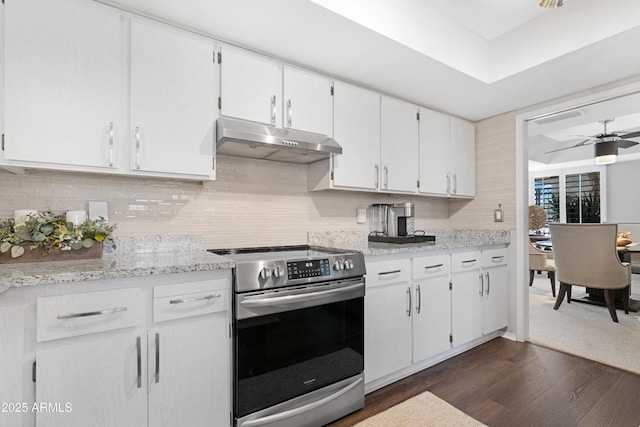 9621 E Calgary Ave, Sun Lakes, AZ 85248 - kitchen with stainless steel electric range oven, under cabinet range hood, dark wood-style floors, and backsplash