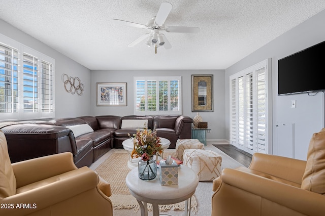 9621 E Calgary Ave, Sun Lakes, AZ 85248 - living room featuring ceiling fan and a textured ceiling