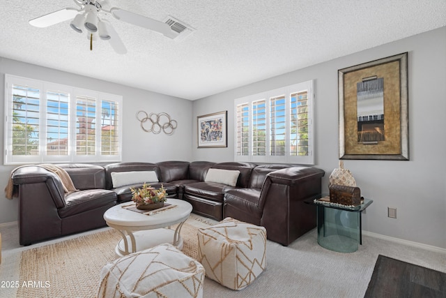 9621 E Calgary Ave, Sun Lakes, AZ 85248 - living room featuring plenty of natural light, carpet flooring, a textured ceiling, ceiling fan, and baseboards