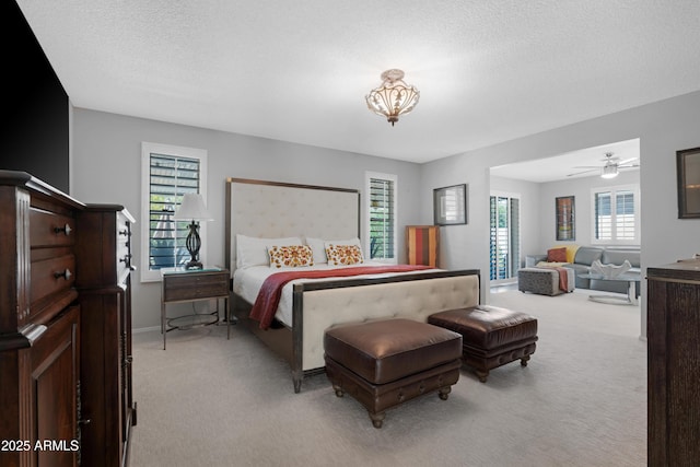 9621 E Calgary Ave, Sun Lakes, AZ 85248 - bedroom with light carpet, a textured ceiling, and baseboards