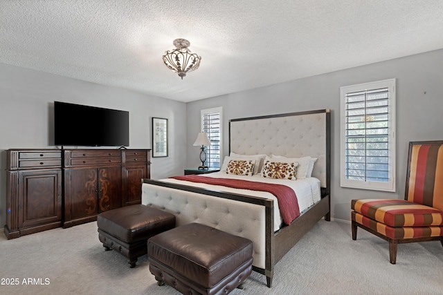 9621 E Calgary Ave, Sun Lakes, AZ 85248 - bedroom with light carpet, a textured ceiling, and baseboards
