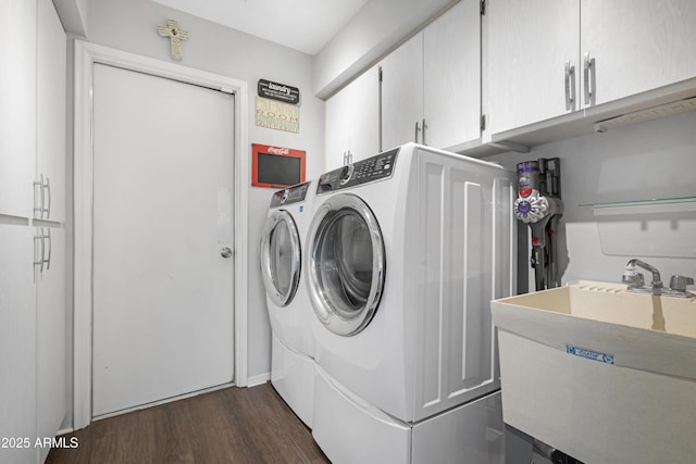 9621 E Calgary Ave, Sun Lakes, AZ 85248 - washroom featuring cabinet space, washing machine and dryer, and dark wood-type flooring