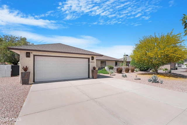 9621 E Calgary Ave, Sun Lakes, AZ 85248 - ranch-style home featuring concrete driveway, stucco siding, a garage, and fence