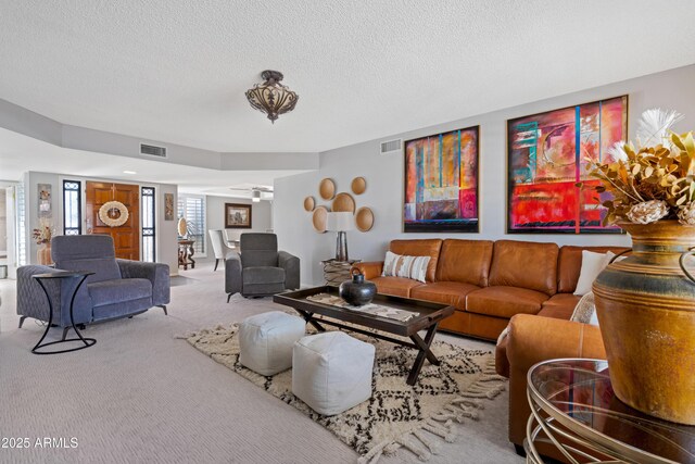 9621 E Calgary Ave, Sun Lakes, AZ 85248 - carpeted living room with a textured ceiling
