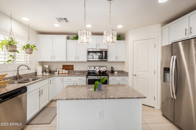 1874 E Mesquite Ave, Apache Junction, AZ 85119 - kitchen with stainless steel appliances, a sink, a center island, white cabinetry, and recessed lighting