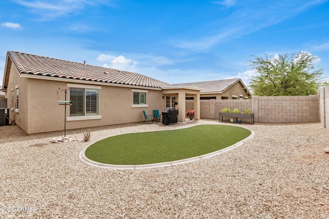 1874 E Mesquite Ave, Apache Junction, AZ 85119 - rear view of property featuring stucco siding, a fenced backyard, a patio area, and a tile roof