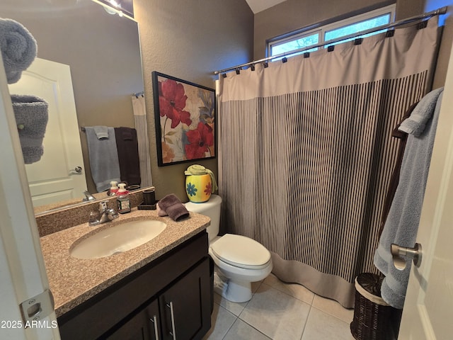 bathroom featuring vanity, tile patterned floors, and toilet