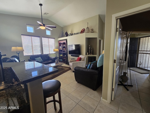 tiled living room featuring lofted ceiling and ceiling fan