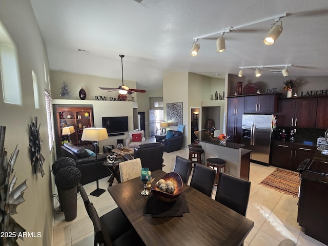 dining room featuring lofted ceiling, light tile patterned floors, and ceiling fan