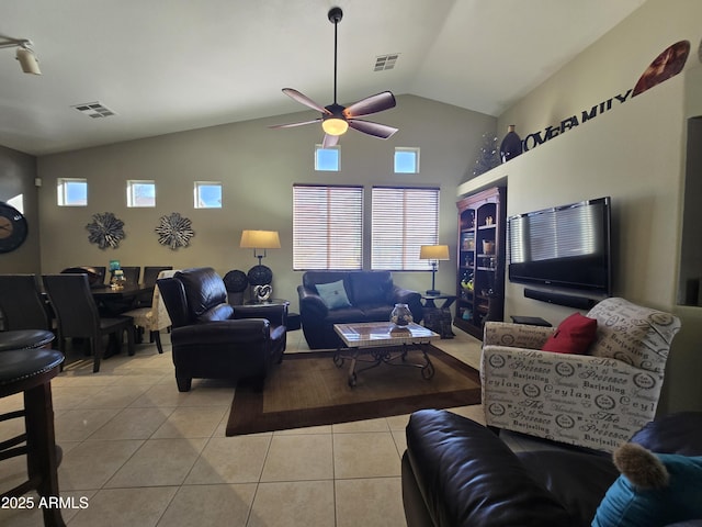 tiled living room featuring high vaulted ceiling and ceiling fan