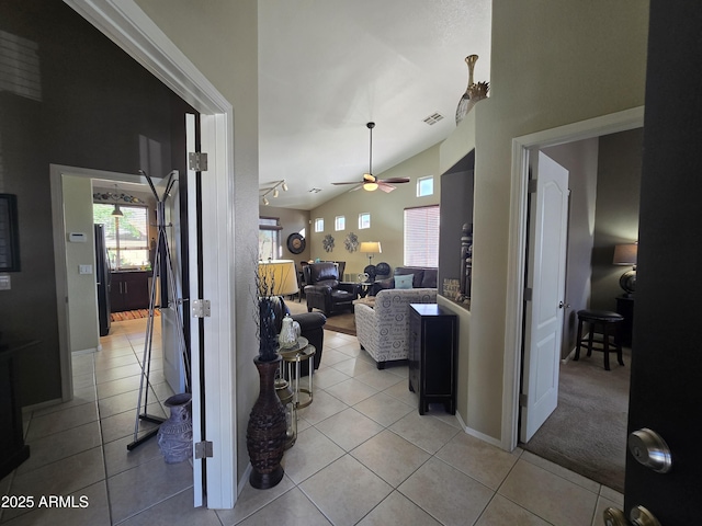 tiled living room featuring lofted ceiling and ceiling fan