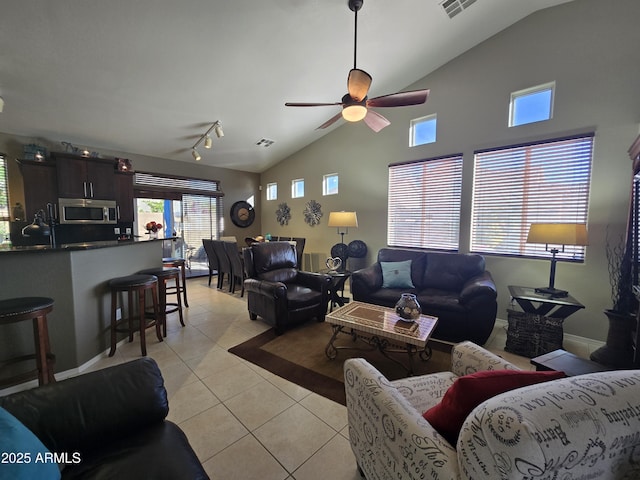 living room featuring high vaulted ceiling, light tile patterned floors, track lighting, and ceiling fan