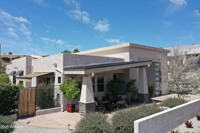 142 Dunn Dr, Page, AZ 86040 - view of property exterior with an outdoor hangout area and stucco siding