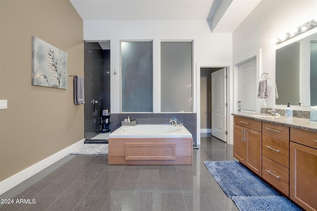 bathroom featuring tile patterned floors, vanity, and shower with separate bathtub