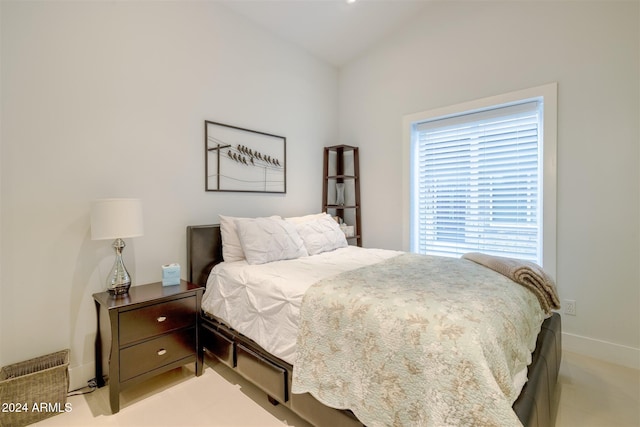 carpeted bedroom with vaulted ceiling