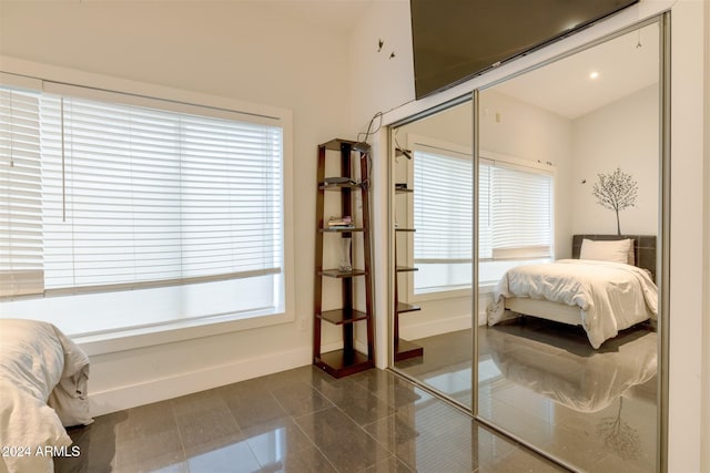 bedroom with multiple windows and a closet