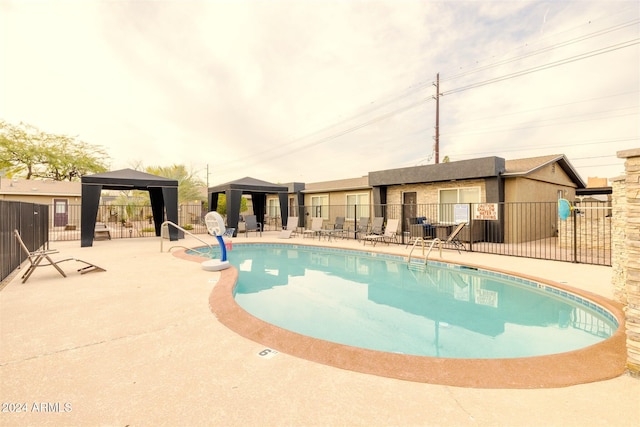 view of swimming pool with a gazebo and a patio area