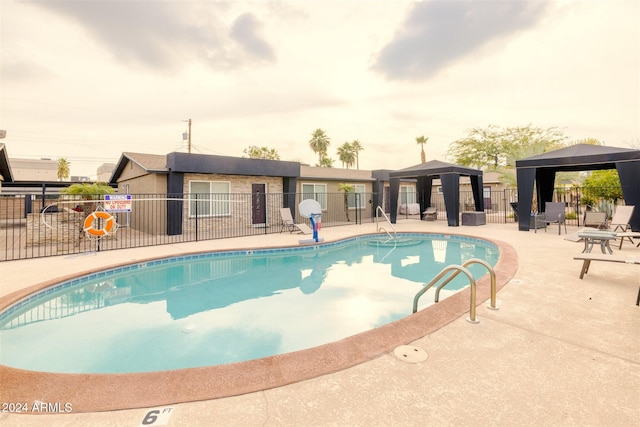 view of swimming pool featuring a gazebo and a patio area