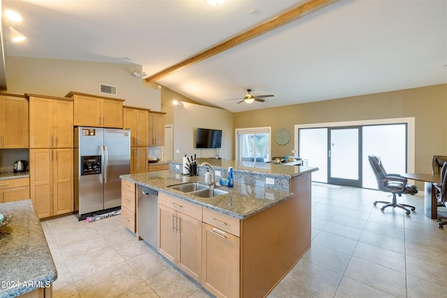 kitchen with light stone countertops, sink, ceiling fan, stainless steel appliances, and lofted ceiling with beams