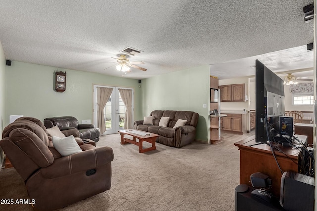 2003 W Tyson St, Chandler, AZ 85224 - living room featuring a textured ceiling, ceiling fan, visible vents, and light colored carpet