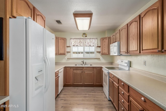 2003 W Tyson St, Chandler, AZ 85224 - kitchen featuring visible vents, open shelves, white appliances, light wood-type flooring, and a sink
