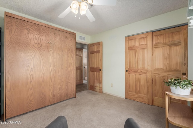 2003 W Tyson St, Chandler, AZ 85224 - unfurnished bedroom with visible vents, a ceiling fan, a textured ceiling, and light colored carpet
