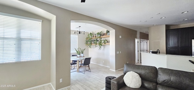 4705 E Red Oak Ln Unit 101, Gilbert, AZ 85297 - living area featuring arched walkways, light wood-style floors, and recessed lighting