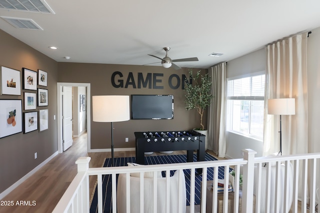 living room featuring hardwood / wood-style floors and ceiling fan