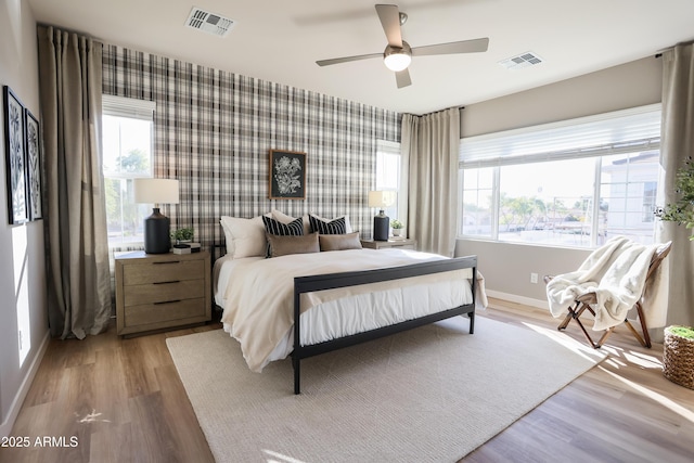 bedroom with light wood-type flooring and ceiling fan