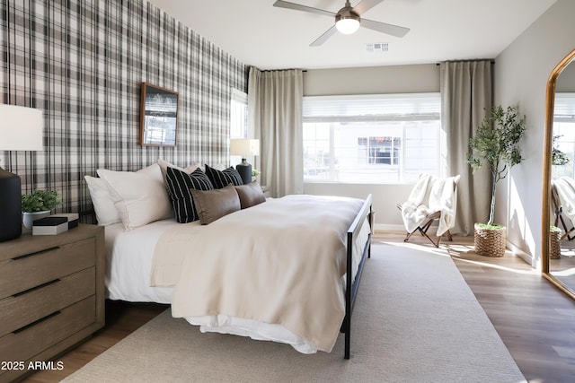 bedroom with ceiling fan and dark wood-type flooring