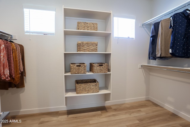 spacious closet with light hardwood / wood-style floors