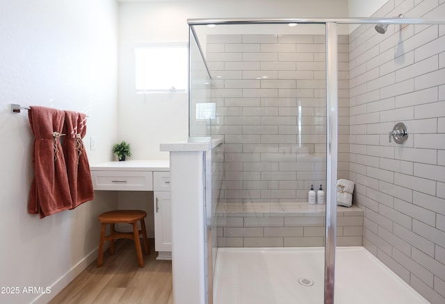 bathroom featuring wood-type flooring and an enclosed shower