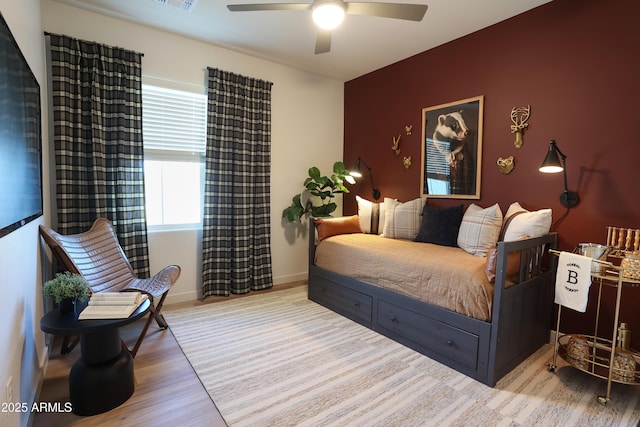 bedroom with ceiling fan and light wood-type flooring