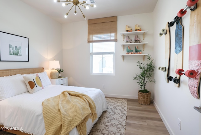 bedroom featuring light hardwood / wood-style floors and an inviting chandelier