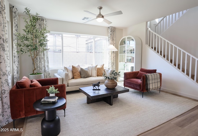 living room with hardwood / wood-style flooring and ceiling fan