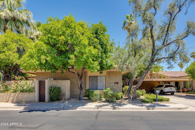 view of front of property featuring a carport