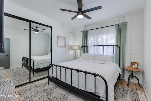 tiled bedroom with ceiling fan