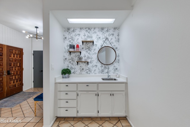 bathroom featuring tile patterned flooring, vanity, and a chandelier