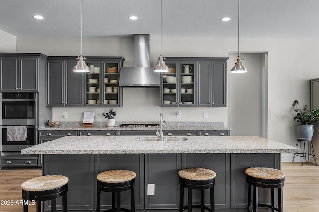 1439 E Mead Dr, Gilbert, AZ 85298 - kitchen with wall chimney range hood, a sink, stainless steel appliances, light wood-style floors, and recessed lighting