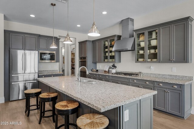 1439 E Mead Dr, Gilbert, AZ 85298 - kitchen with stainless steel appliances, wall chimney exhaust hood, a sink, light wood-style flooring, and recessed lighting